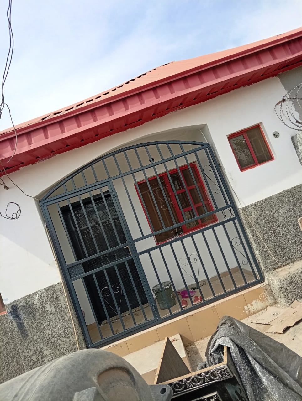a beautifuly painted house with red roofing.