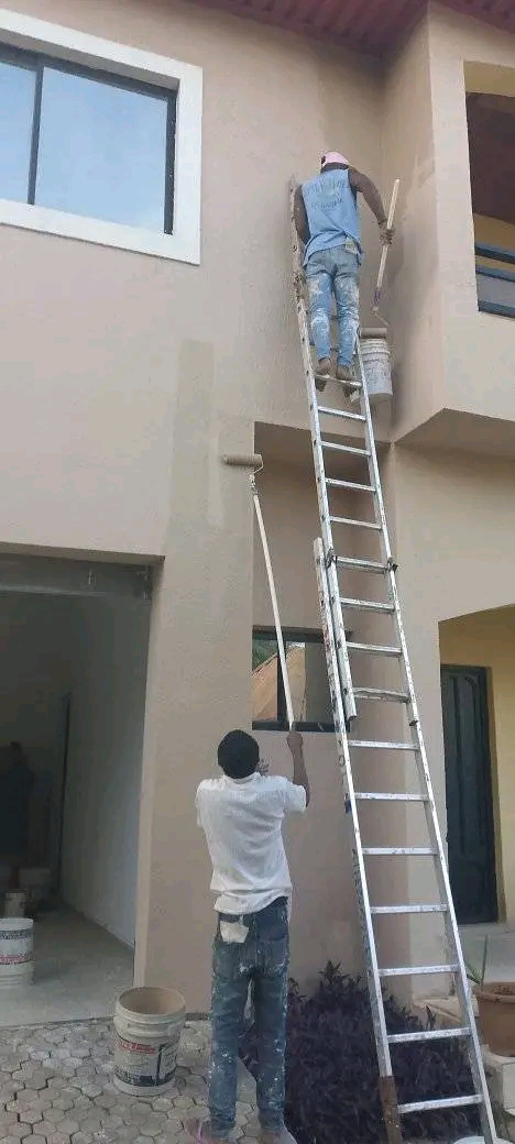 men working on a storey building.